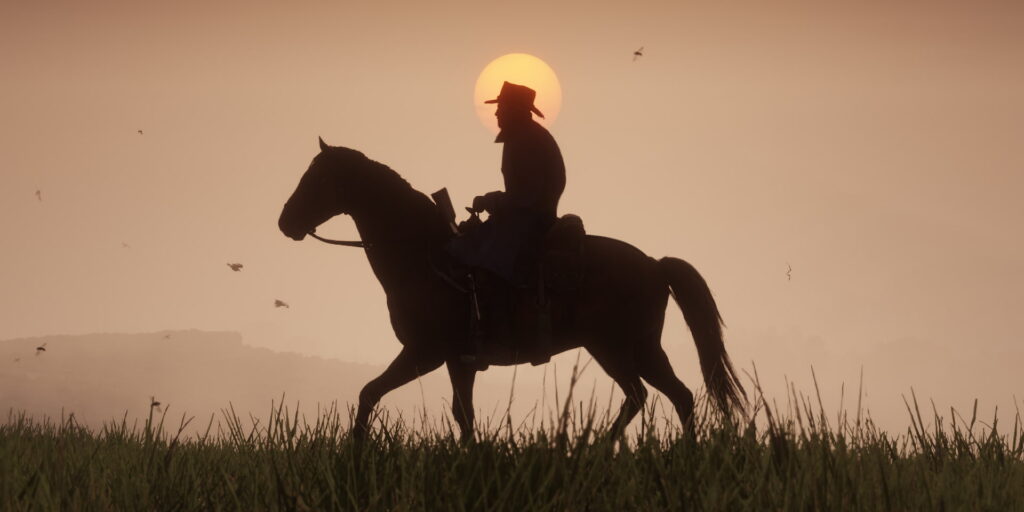 Arthur Morgan riding his horse at sunset in Red Dead Redemption 2